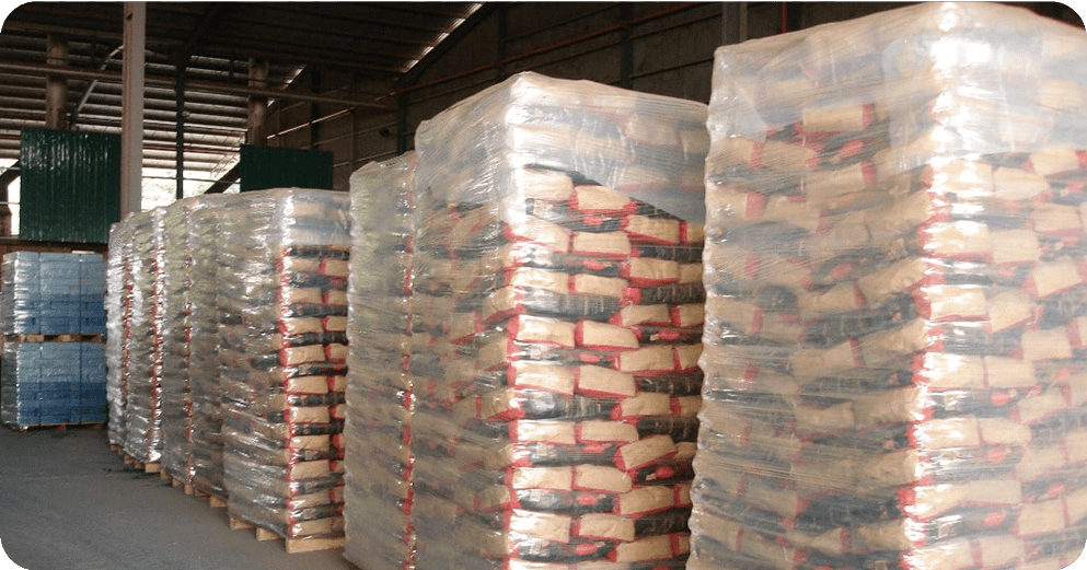 pallets of Sawdust Briquettes Charcoal in a warehouse